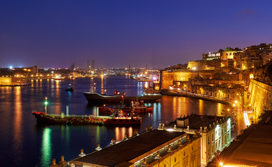 The night view of Grand Harbour with the cargo ships moored near