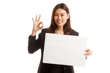 Young Asian business woman show OK with  white blank sign.