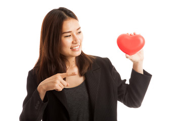 Asian business woman point to red heart.