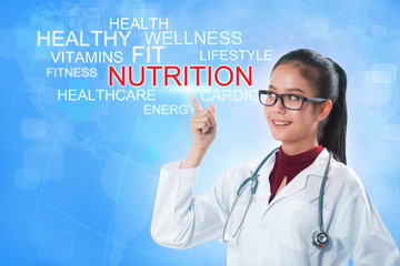 Doctor hand touching nutrition word on screen with blue background. medical concept