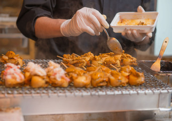 Chefs are cooking grilled shell on the japan market.