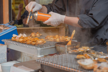 Chefs are cooking grilled shell on the japan market.