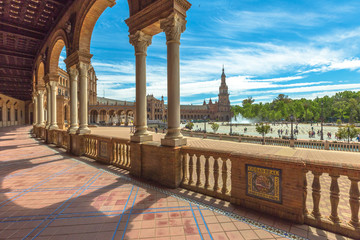 Fototapeta na wymiar The famous Square of Spain, in Spanish Plaza de Espana, view from the path with columns. Seville, Andalusia, Spain.