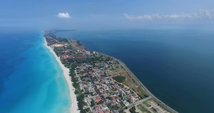 Bird's-eye view to main streets, houses and coastline of Varadero. Drone flies over tropical island in the Atlantic Ocean.