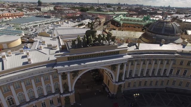 Palace Square from above aerial quadcopter flightover. Best St.Petersburg drone footage. Winter palace hermitage museum facade. Alexander column with angel and cross. People walking, sunny day.