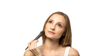 Obraz premium Portrait of beautiful young women applying blush.