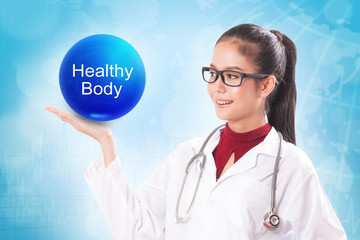 Female doctor holding blue crystal ball with healthy body sign on medical background.