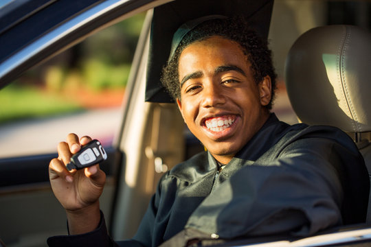 African American Teenager With A New Car. Graduation Gift.