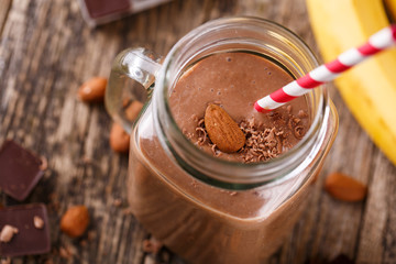 Detox chocolate smoothie with nuts in glass jar.