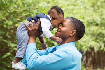 African American father and son - Powered by Adobe