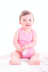 Baby girl with pink baby bottle. 