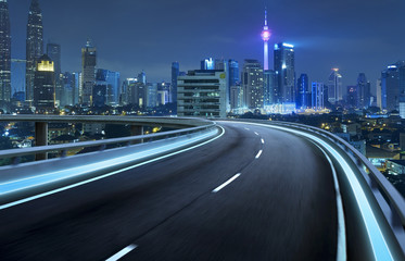 Fototapeta na wymiar Highway overpass motion blur with city background .