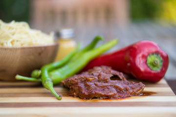 Beef with tomato sauce, sphagetti and vegetables.