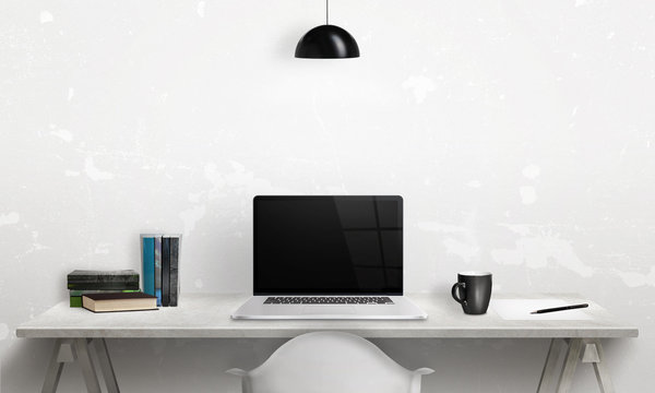 Writing book on a laptop. Clean scene of the desk in office or room. Blank screen for mockup.