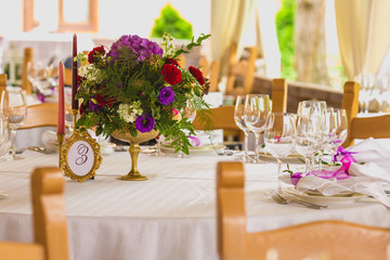 flower composition and candles in the restaurant. Wedding dinner
