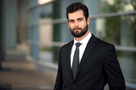 Headshot pose portrait of a modern attractive business man with a beard
