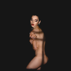 Naked woman with shadows on body