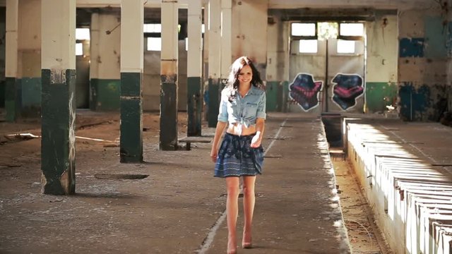 Beautiful girl walking in an abandoned building