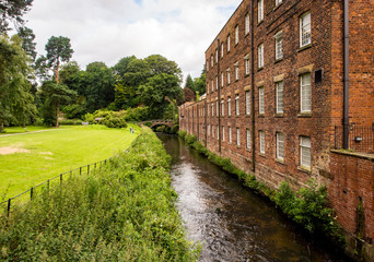 Styal, Cheshire, UK. July 26th 2016. Quarry Bank Mill in countryside setting on cloudy summer day, Styal, Cheshire, UK