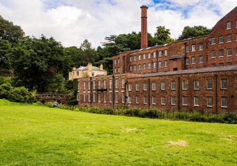Styal, Cheshire, UK. July 26th 2016. Quarry Bank Mill in countryside setting on cloudy summer day, Styal, Cheshire, UK