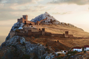 Ancient Genoese fortress in Sudak town. Panorama view at sunset.