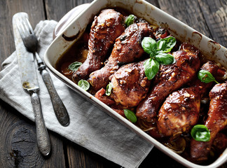 Fried chicken legs with vegetables. rustic style