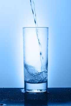 Beautiful glass with water on a blue background