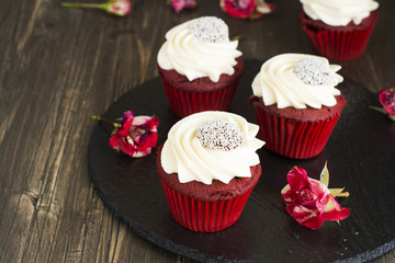 Red velvet cupcakes over wooden background