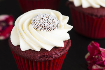 Red velvet cupcakes over wooden background