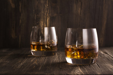 Cognac in glasses over wooden table