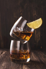 Cognac in glasses over wooden table