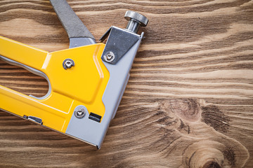 Construction staple on wooden board top view maintenance concept