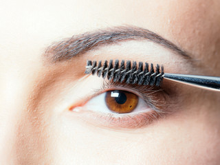 pretty woman with mascara brush