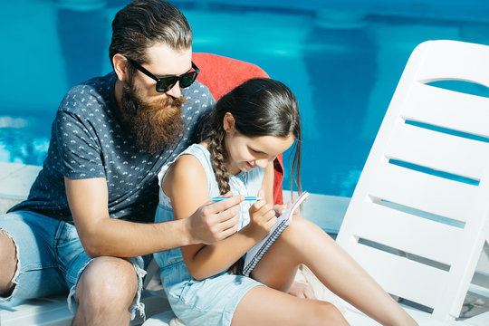 Happy Small Girl And Man At Swimming Pool