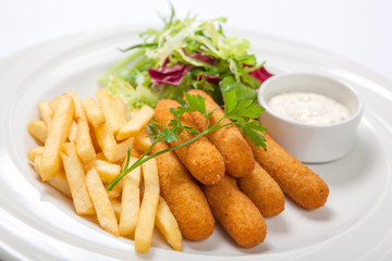 Fish sticks with sauce, fried potatoes and fresh salad lettuce on a white plate