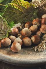 Hazelnuts and leaves on coming out of burlap bag