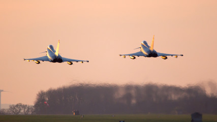Two fighter jets take off from their airbase