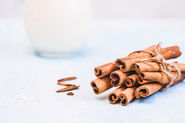 Ground cinnamon, sticks, tied with jute rope on old wooden background, selective focus, space for text, instagram filter