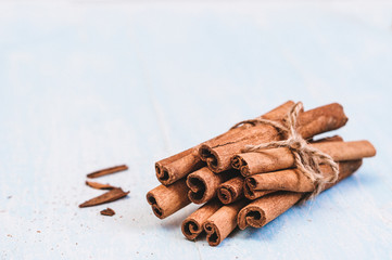 Ground cinnamon, sticks, tied with jute rope on old wooden background, selective focus, space for text, instagram filter