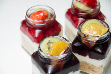  Dessert with blueberries and cherry in glass bottle