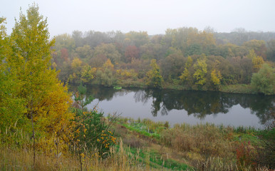 River landscape and autumn wood