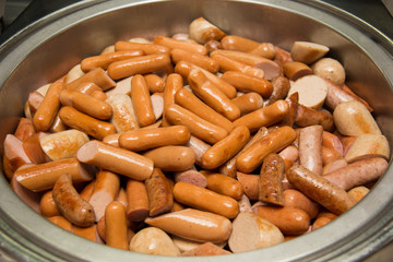  Cutting german sausage and meat in dish