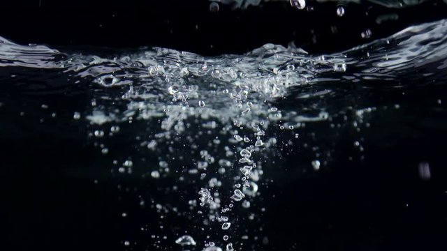 Slow motion of touchscreen smart phone with incoming call on display falling in water with splashes