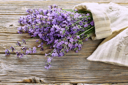 Bouquet of lavender with linen aroma sack on wooden table 