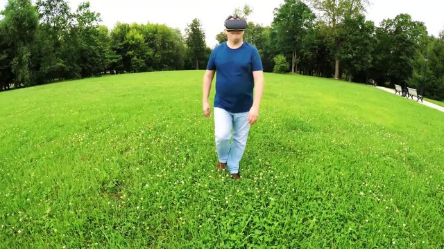Plus size man wearing virtual reality goggles outdoors First experience in 3d entertainment