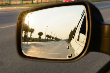Reflection of a city street in the mirror car