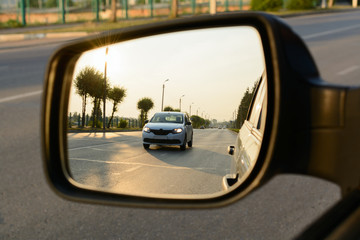 Reflection of a city street in the mirror car