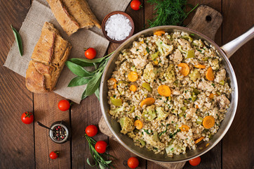 Tasty pearl barley porridge with vegetables and chicken. Top view