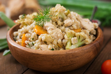 Tasty pearl barley porridge with vegetables and chicken