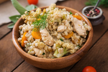 Tasty pearl barley porridge with vegetables and chicken